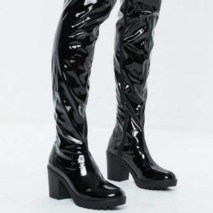 Black patent cleated sole vinyl boots